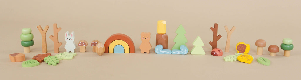 Set of colorful wooden toys on a beige background