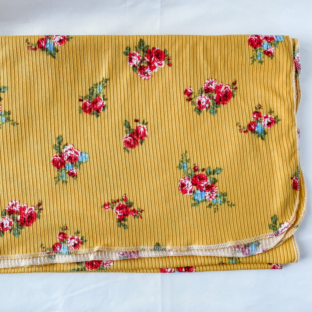 Yellow fabric with floral pattern on a white background