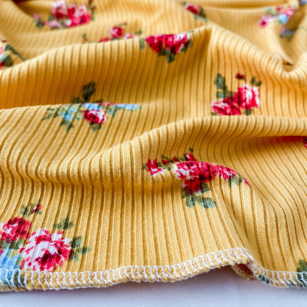 Yellow fabric with floral patterns on a white background