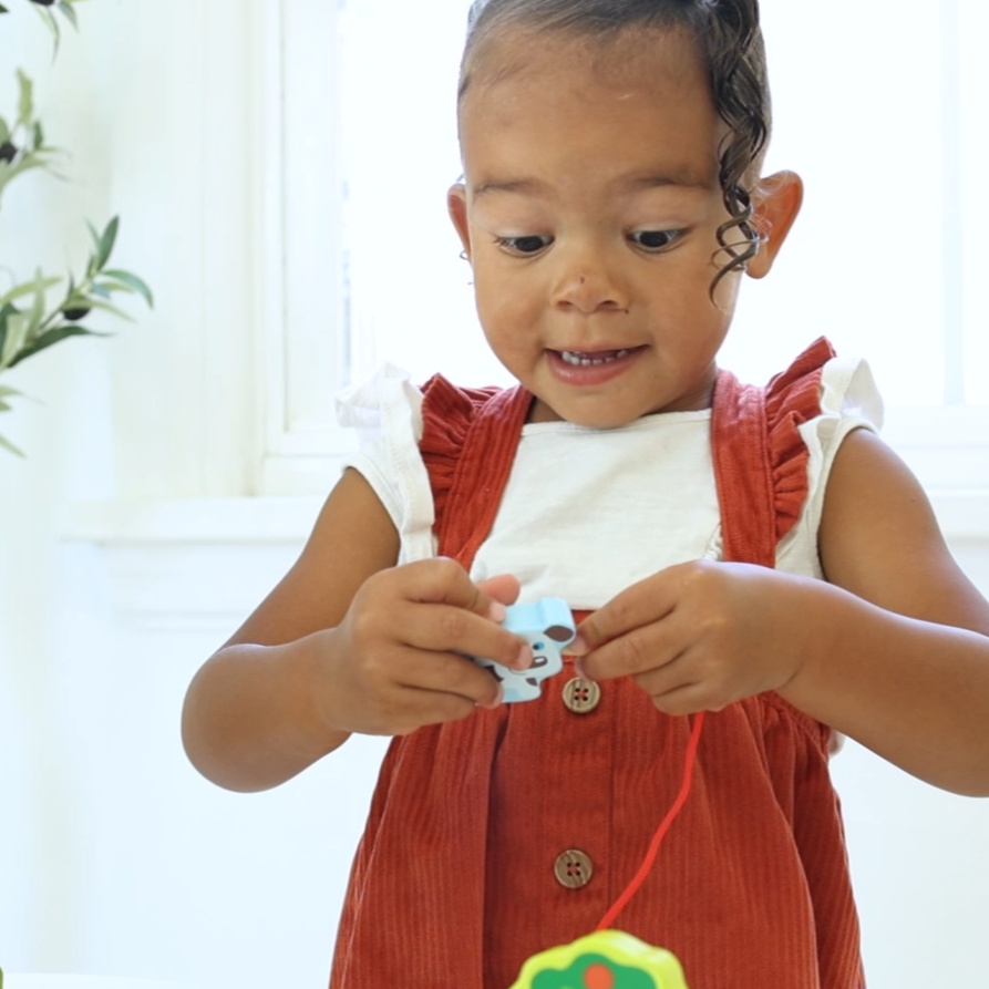 Child playing with a toy in a bright room