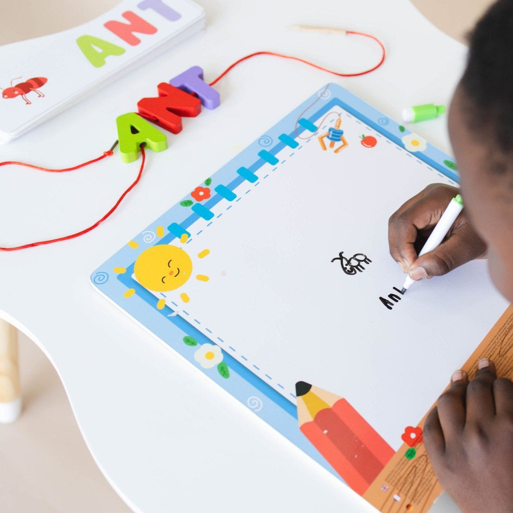 Child writing ant on whiteboard